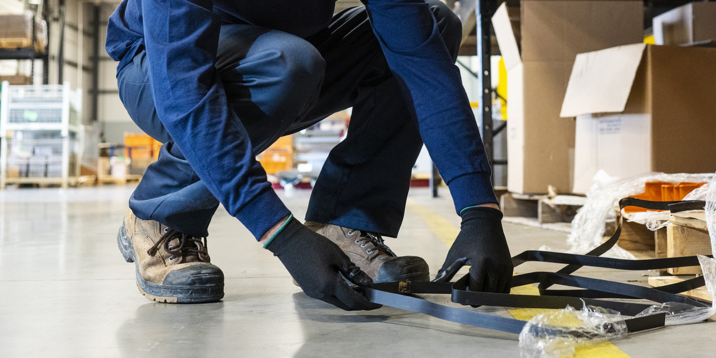 manufacturing worker repairing a damaged item, preventing any safety issues