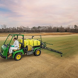 Photo of turf maintenance vehicle spraying a field